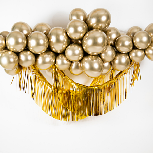 gouden ballonnenboog en franje slinger
