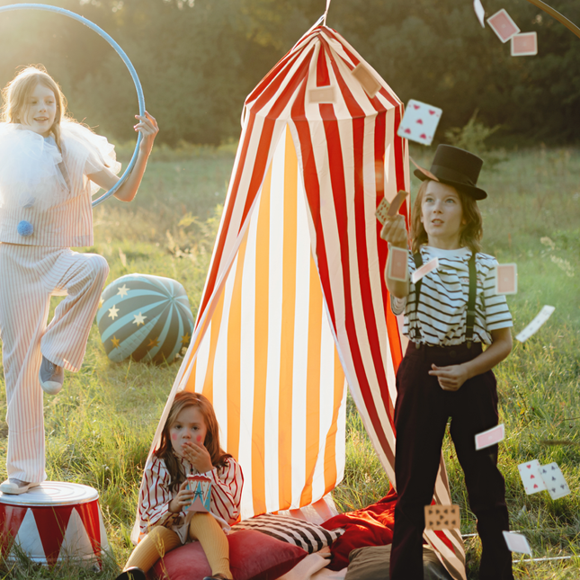 kinderen spelen bij een rood witte circustent