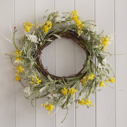 Vrolijke deurkrans met gele en witte bloemen en groene met bruine takjes