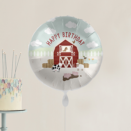 Ballon bedrukt met boerderijdieren zoals een koe, paars en varkens en de tekst happy birthday in het rood