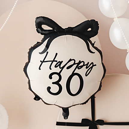 zwart met creme folieballon happy 30 met een strik bovenop de ballon