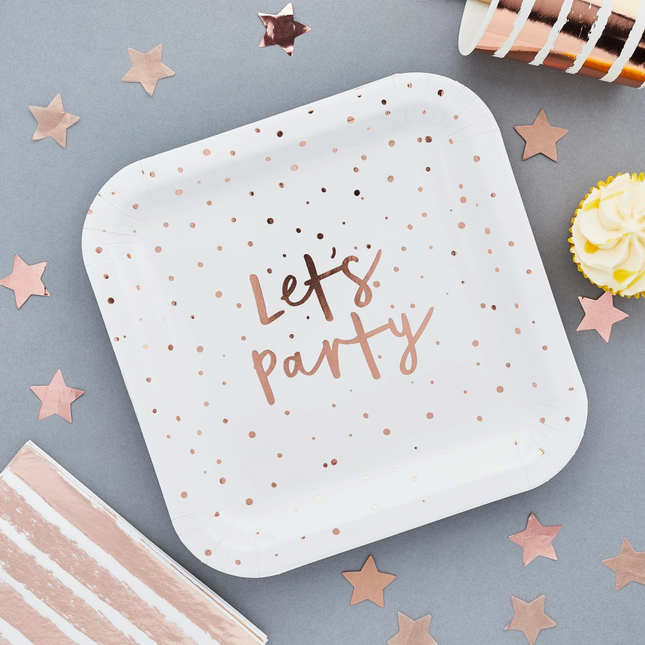 wit vierkant bordje met rose gouden stippen en de tekst lets party