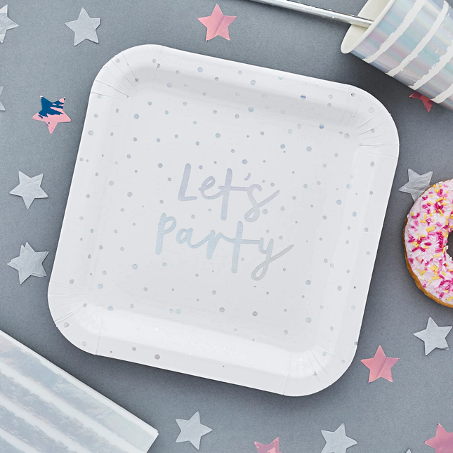 wit met iridescent bordje in het vierkant op een grijze tafel met holografische sterren confetti