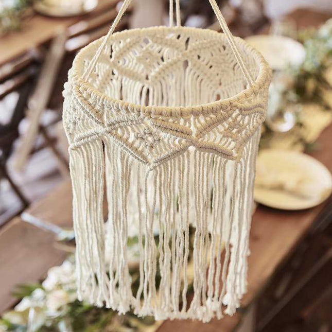 Macrame kroonluchter boven gedekte tafel