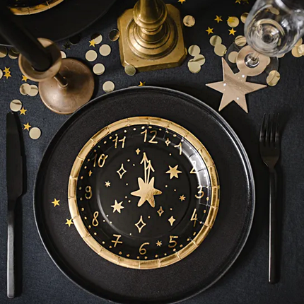 Tafel gedekt met zwart en gouden oud en nieuw versiering