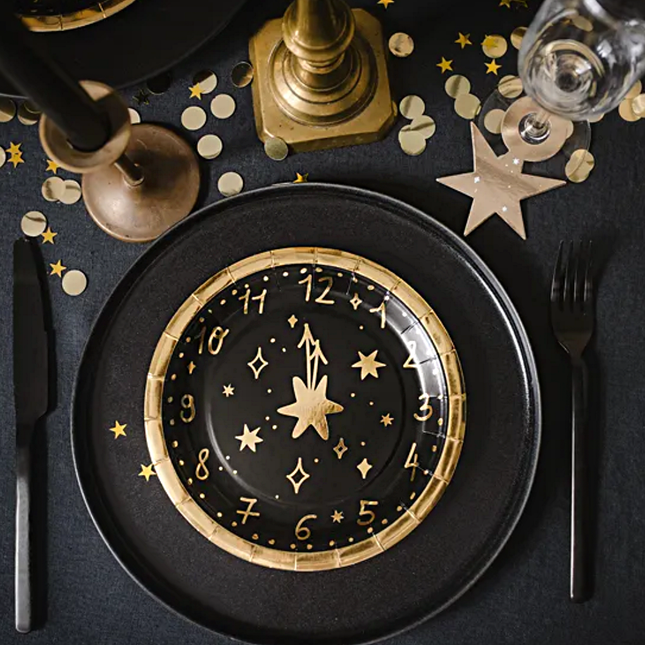 Tafel gedekt met zwart en gouden oud en nieuw versiering