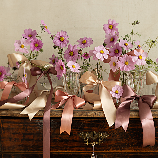 vaasjes met bloemen versierd met perzik goud en rosé gouden lint